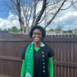 Photo of Dr. Soares standing in front of a fence